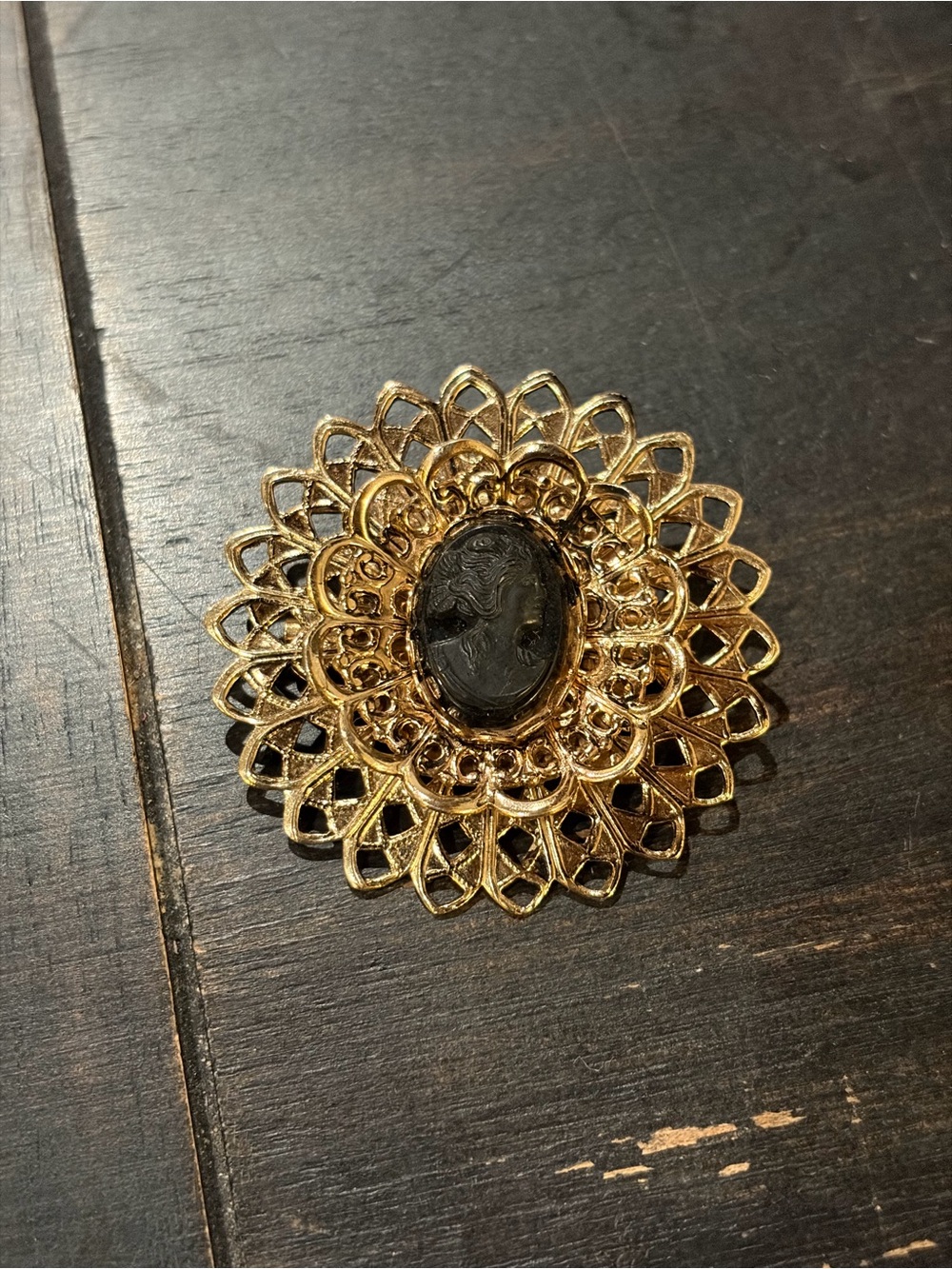 Gold and black filigree cameo brooch
